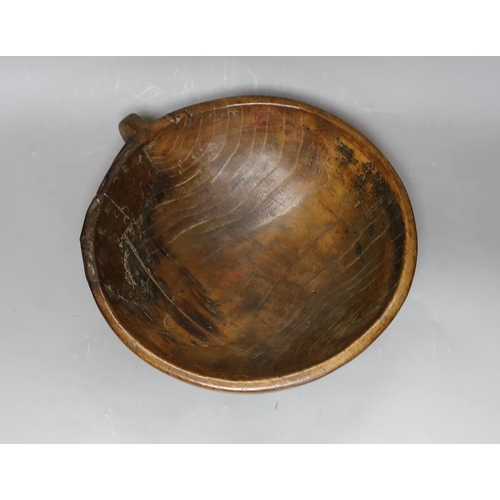 294 - A carved elm mazer bowl, with old blacksmith repair, 31cm diameter