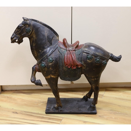 304 - A Chinese carved and painted wood horse, 56cm tall