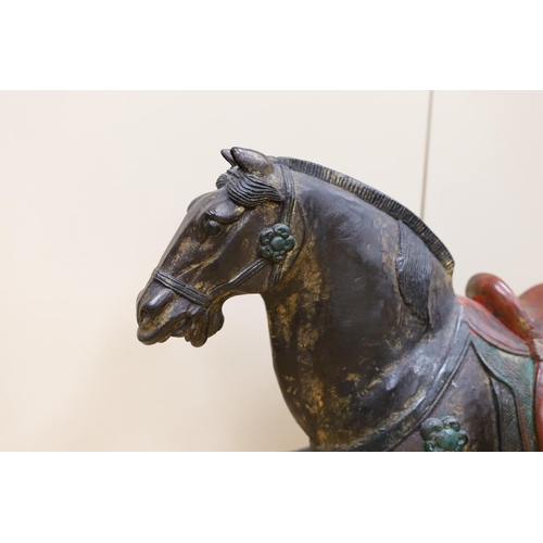 304 - A Chinese carved and painted wood horse, 56cm tall