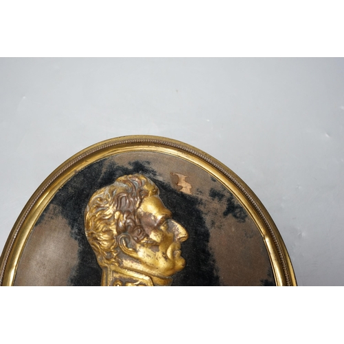 337 - A gilt metal portrait profile relief, The Duke of Wellington, set on black velvet ground, brass fram... 