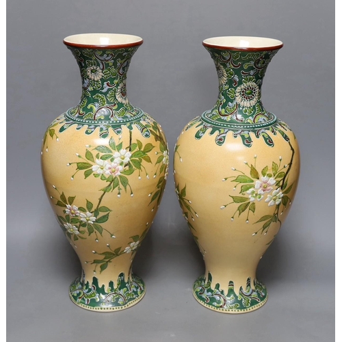 350 - A pair of Japanese Satsuma style cream ground moriage vases, 40cm