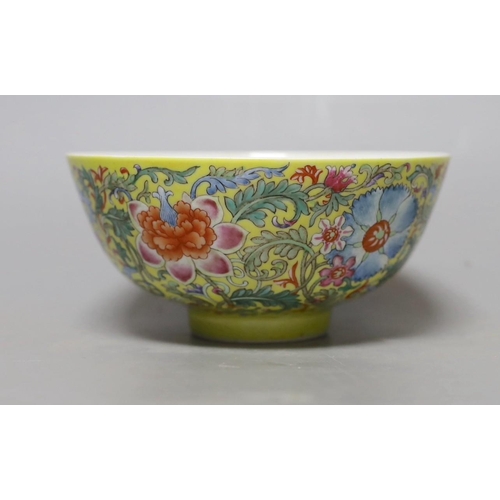 365 - A Chinese yellow ground famille rose floral bowl, 15cm