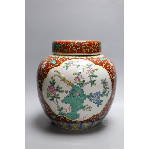 407 - A Chinese coral ground jar and cover, 23cm