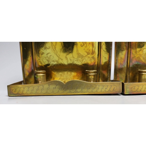 430 - A pair of Arts and Crafts Dutch style brass candle wall sconces, 31cm tall