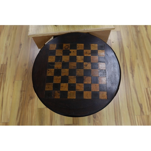 443 - A stained pine inlaid chessboard top table, 75cm high, 56cm diameter and a set of Staunton chess pie... 