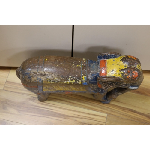 449 - A large painted Indian hardwood elephant. 63cm wide