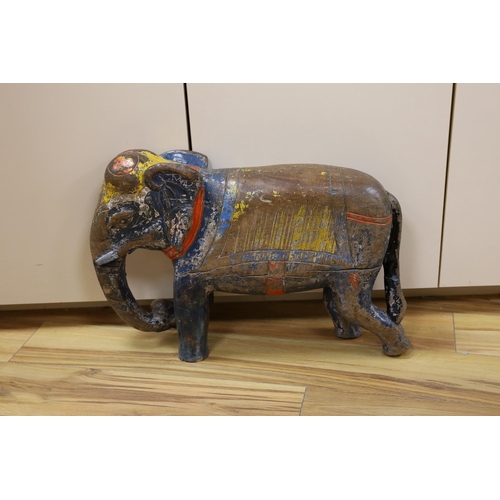 449 - A large painted Indian hardwood elephant. 63cm wide