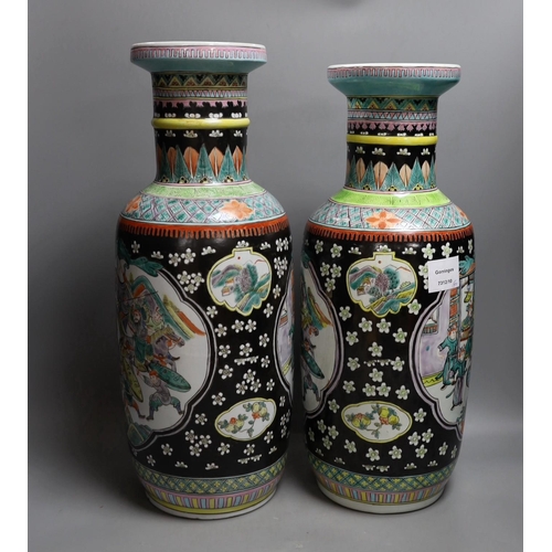 454 - A near pair of Chinese black ground rouleau vases. 47.5cm high