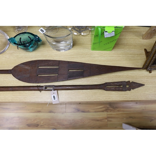 484 - A pair of carved wood paddles, possibly Polynesian. 155cm long