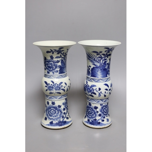 502 - A pair of 19th century Chinese blue and white beaker vases, 23.5cm