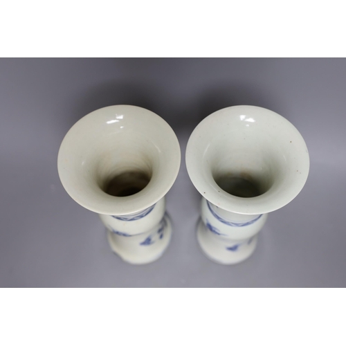 502 - A pair of 19th century Chinese blue and white beaker vases, 23.5cm