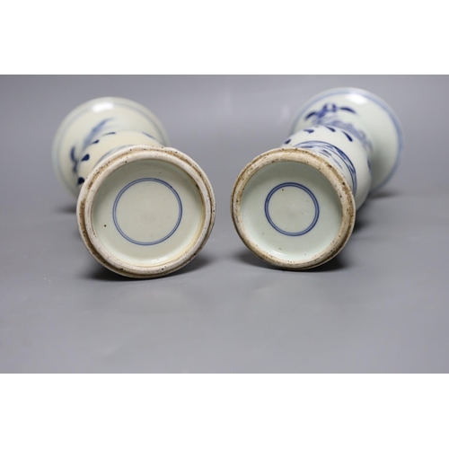 502 - A pair of 19th century Chinese blue and white beaker vases, 23.5cm