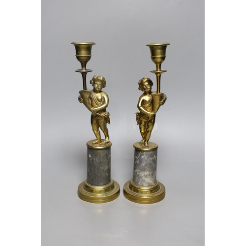 503 - A pair of early 20th century gilt brass figural candlesticks, 27.5cm