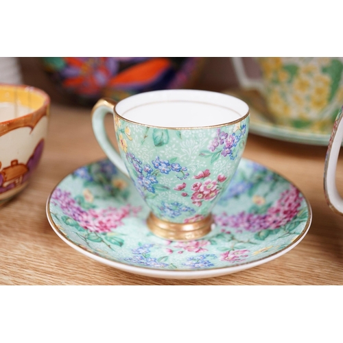 513 - A Clarice Cliff tea cup, a collection of chintz patterned teaware, a lustre bowl and a honey pot and... 