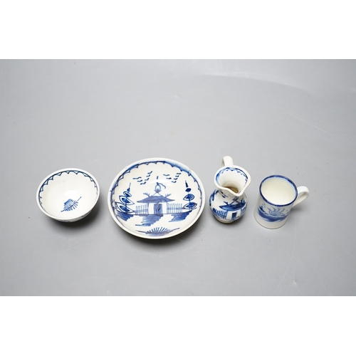 530 - A late 18th century pearlware blue and white miniature jug, 5cm, and tea bowl and an English porcela... 