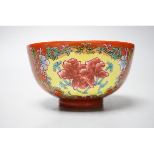 559 - A Chinese famille rose coral ground bowl, 11cm diameter