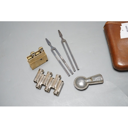 599 - Tuning forks etc. In a leather White Horse cigar case