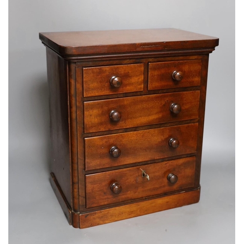 624 - A Victorian miniature chest with five drawers and a key, 38cm tall