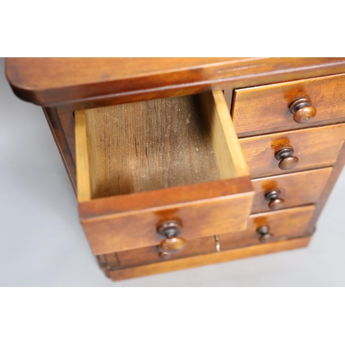 624 - A Victorian miniature chest with five drawers and a key, 38cm tall