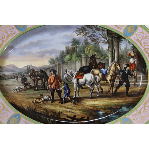 638 - A large Vienna style porcelain oval dish, late 19th century, painted with huntsmen and horses in a l... 