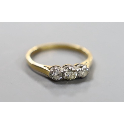 921 - An 18ct, plat and three stone diamond set ring, size J, gross weight 2 grams.