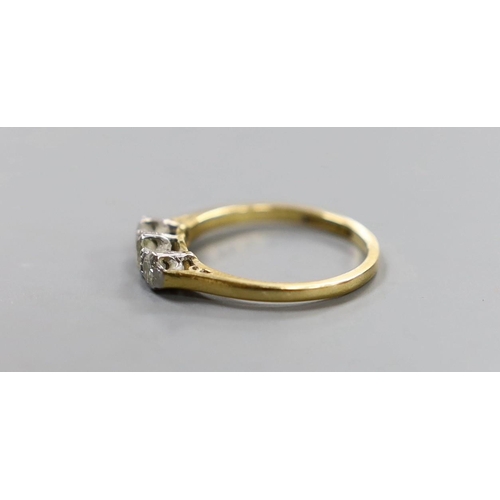 921 - An 18ct, plat and three stone diamond set ring, size J, gross weight 2 grams.