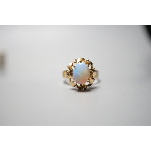 929 - A 14k yellow metal and white opal set oval dress ring, size O, gross weight 3.9 grams.