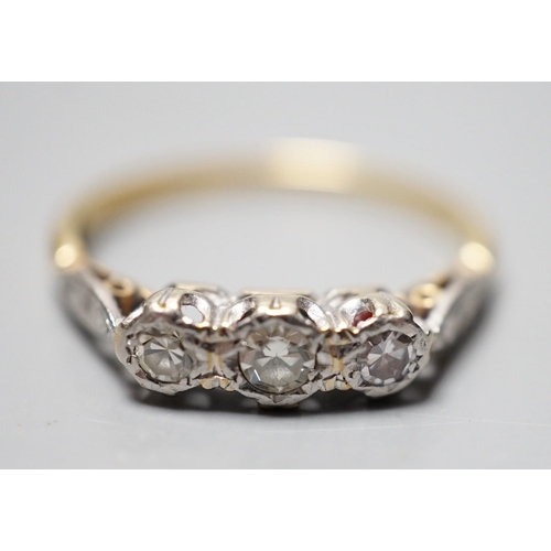 930 - A yellow metal and illusion set three stone diamond ring, size O, gross weight 2.4 grams.