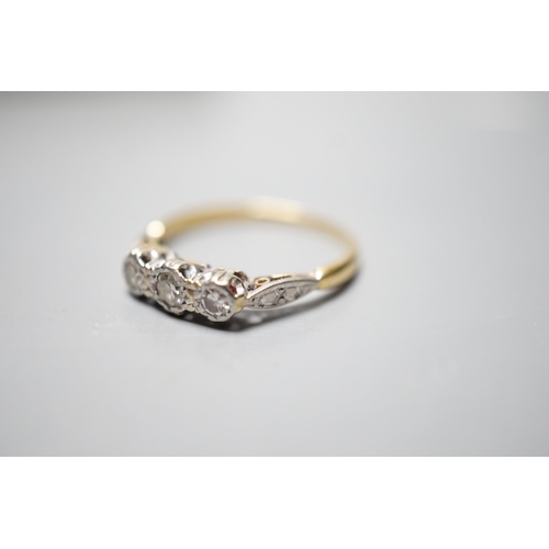 930 - A yellow metal and illusion set three stone diamond ring, size O, gross weight 2.4 grams.