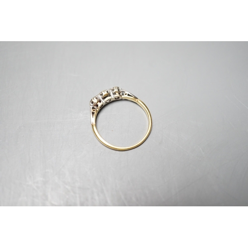 930 - A yellow metal and illusion set three stone diamond ring, size O, gross weight 2.4 grams.