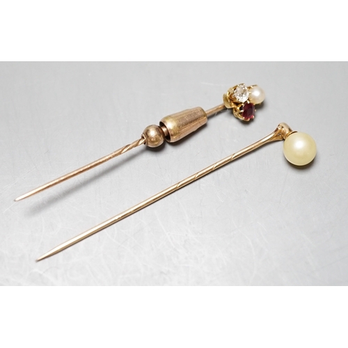 931 - An early 20th century yellow metal, ruby, diamond and cultured pearl cluster set stick pin, 58mm and... 