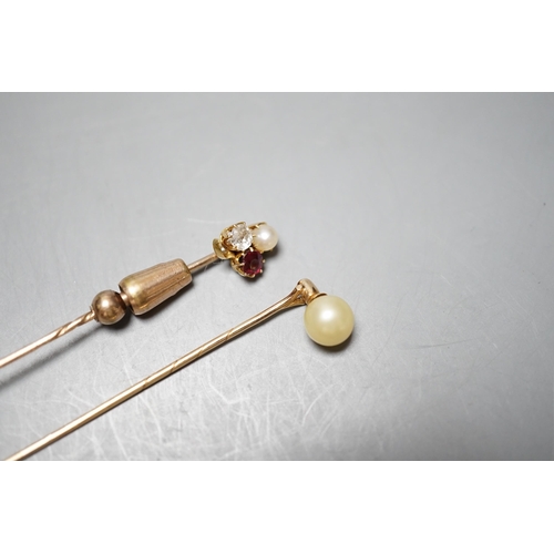 931 - An early 20th century yellow metal, ruby, diamond and cultured pearl cluster set stick pin, 58mm and... 