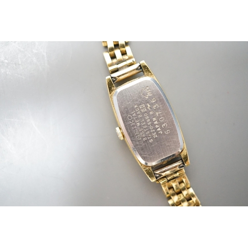 934 - A lady's steel and gold plated Seiko quartz wrist watch, on an 18ct gold bracelet, gross weight 16.7... 