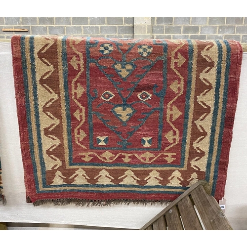 1016 - A Kilim runner with geometric motifs on a red ground, 394 x 96cm