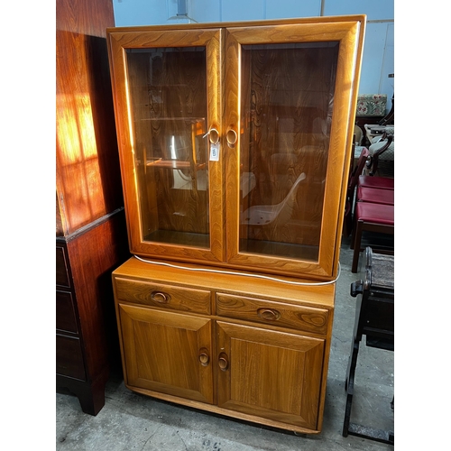 1023 - An Ercol elm 'Windsor' glazed side cabinet, width 91cm, depth 43cm, height 162cm