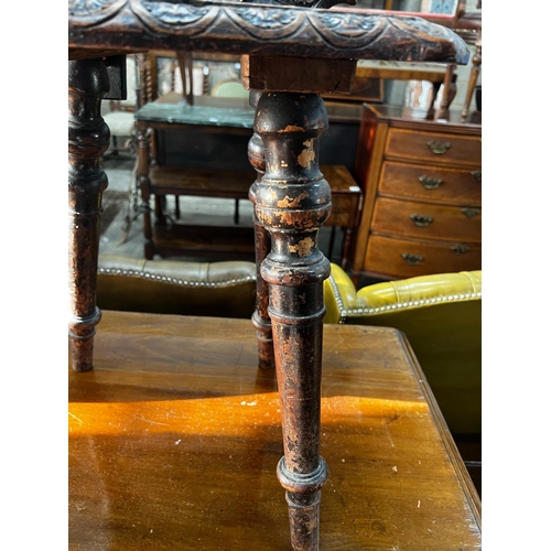 1032 - A 19th century Tyrolean oak hall chair, the back carved with a mask, a shell and serpents, height 94... 