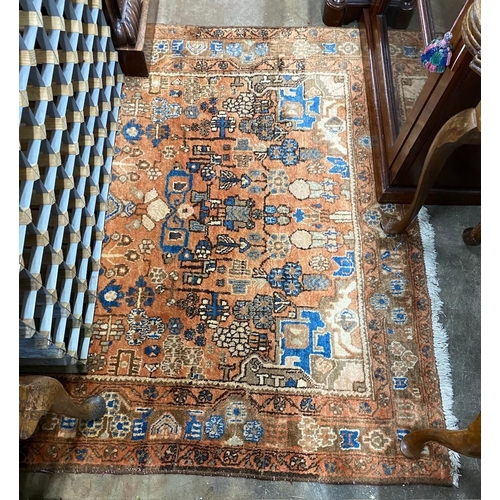 1044 - A Caucasian style peach ground rug, 230 x 146cm