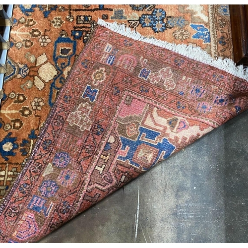 1044 - A Caucasian style peach ground rug, 230 x 146cm