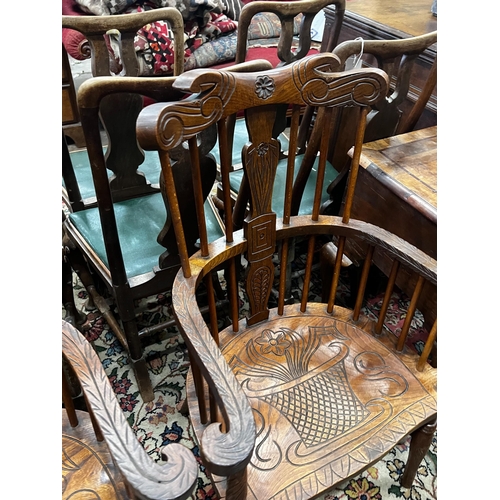 1046 - A pair of carved elm Windsor armchairs, width 69cm, depth 45cm, height 107cm