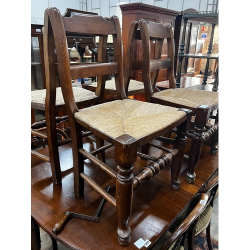 1056 - A set of four 19th century provincial elm and fruitwood rush seat dining chairs, height 87cm