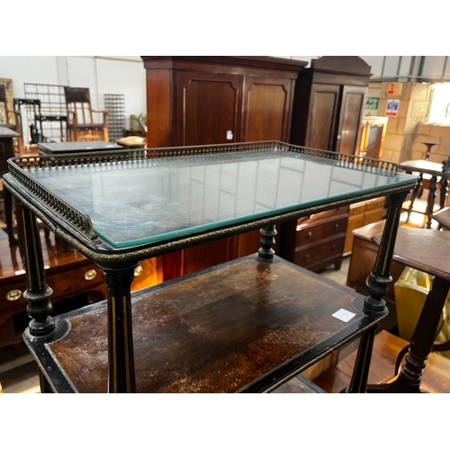 1057 - A late Victorian ebonised and amboyna three tier whatnot, width 66cm, depth 39cm, height 81cm