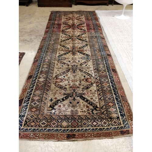 1013 - An antique Caucasian ivory ground hall carpet, 382 x 142cm