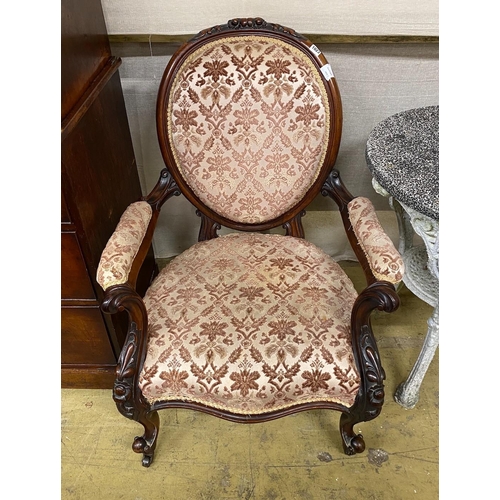 1023 - A Victorian carved walnut spoon back open armchair, width 71cm, depth 60cm, height 95cm