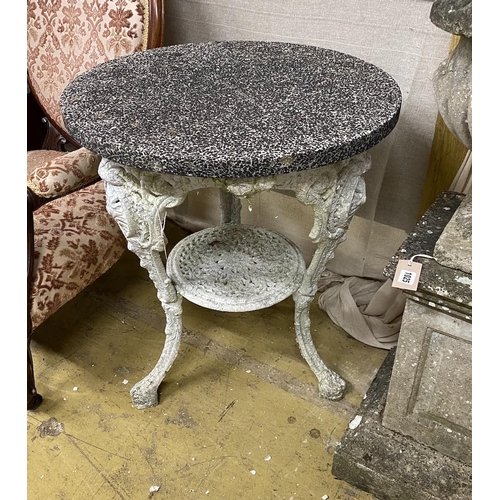 1024 - A Victorian cast iron circular garden table with weathered stone top, diameter 61cm, height 72cm... 