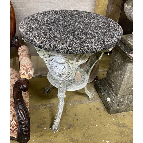 1024 - A Victorian cast iron circular garden table with weathered stone top, diameter 61cm, height 72cm... 