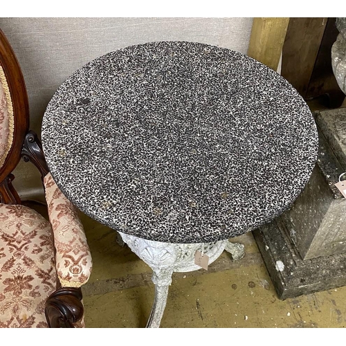 1024 - A Victorian cast iron circular garden table with weathered stone top, diameter 61cm, height 72cm... 