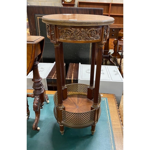 1028 - A circular French gilt metal mounted two tier table, diameter 36cm, height 74cm