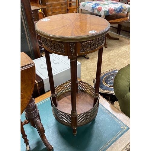 1028 - A circular French gilt metal mounted two tier table, diameter 36cm, height 74cm