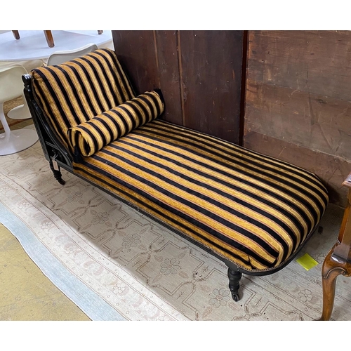 1033 - An Aesthetic period ebonised chaise longue, in the manner of E. W. Godwin, length 164cms, depth 61cm... 