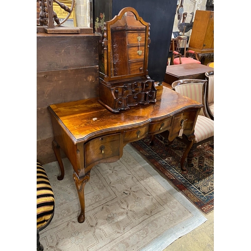 1035 - A Queen Anne Revival serpentine walnut kneehole dressing table, width 121cm, depth 54cm, height 76cm... 